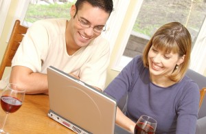 Smiling couple with laptop