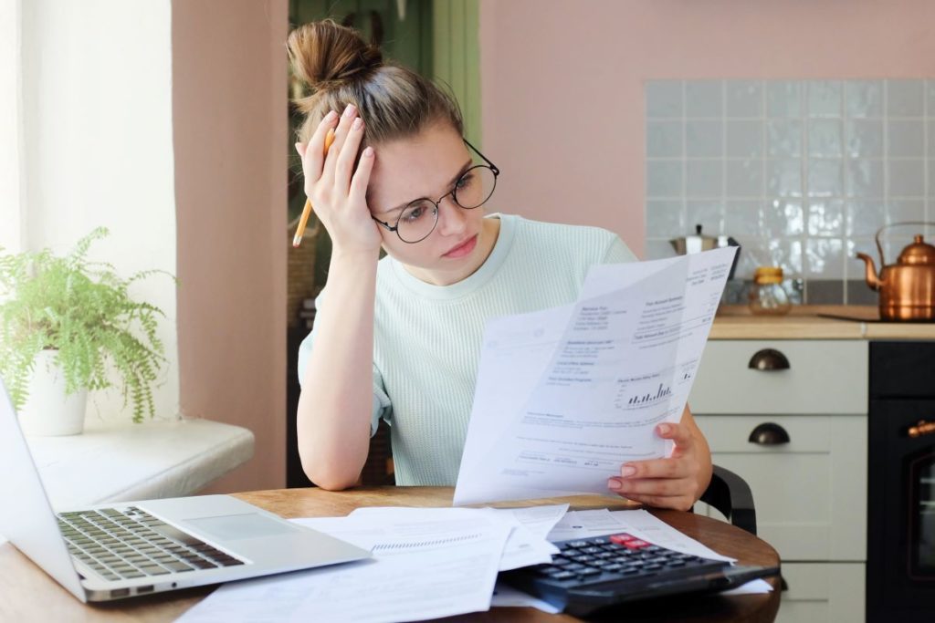 frustrated woman looking at papers
