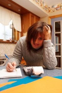 frustrated woman with a paper and calculator