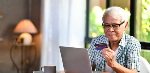 senior man using a credit card