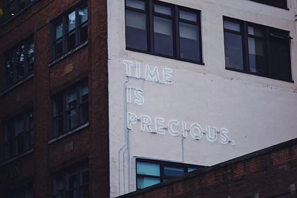 a sign saying "time is precious" on a building